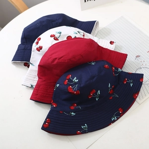 Kids reversible bucket hat with cherry print and solid colors for sun protection