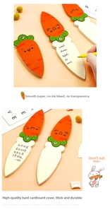 Detailed view of the thick carrot-shaped notepad with smooth writing inner pages