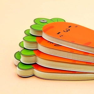 Creative carrot-shaped spiral notebooks in orange and green for students and gift-giving