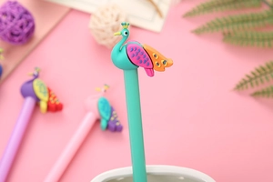 Close-up of green peacock cartoon gel pen with colorful wings and silicone topper