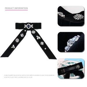 Detailed view of black velvet bow hair clip with crystals and metal spring clasp
