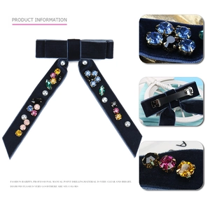 Macro view of blue velvet bow hair clip with colorful crystals and pearl inlay