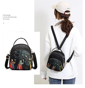 Close-up of waterproof black oxford fabric and artistic ethnic pattern on mini backpack