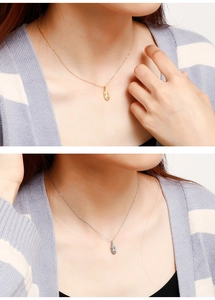Detail view of gold and silver stainless steel necklaces with oval relief portrait pendants