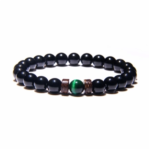 Men's yoga energy bracelet with black volcanic stone, coconut wood, and green cat eye bead