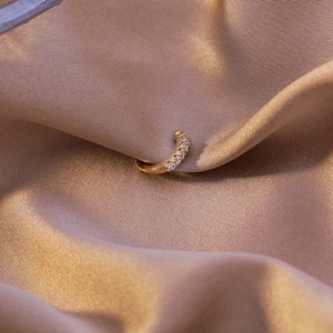 Elegant gold flower star ear cuff with micro-set zircon on champagne silk fabric