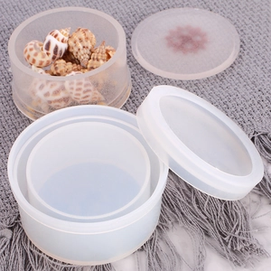 Close-up of translucent round silicone resin molds with lids and decorative shells