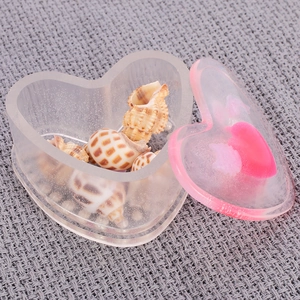 Close-up of heart-shaped silicone resin mold storage box with decorative lid and shells