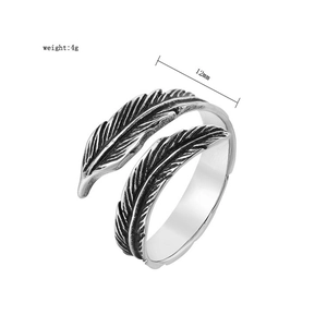 Detailed macro view of retro silver feather ring showing 12mm width and 4g weight