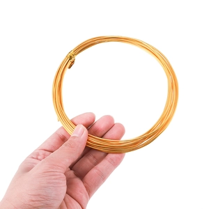 Coil of golden colored aluminum craft wire for DIY jewelry and wire wrapping