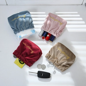 Flat lay of velvet drawstring bags with Beautyforyou gold embroidery in four colors