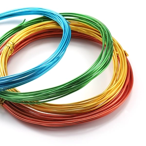 Rolls of colorful craft aluminum wire in blue, green, yellow, and red for DIY jewelry