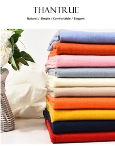 Detailed stack of thick cashmere-like scarves in vibrant colors for autumn and winter wear