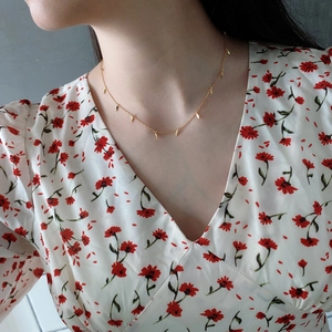 Minimalist 925 sterling silver gold necklace with leaf charms worn by model