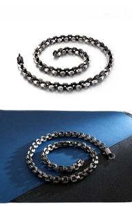 Detail of geometric titanium steel chain with vintage matte texture and dragon-bone clasp
