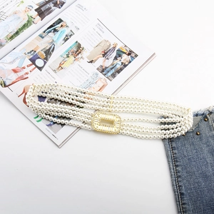 Detailed close-up of four-layer pearl waist chain with a sparkling rhinestone buckle