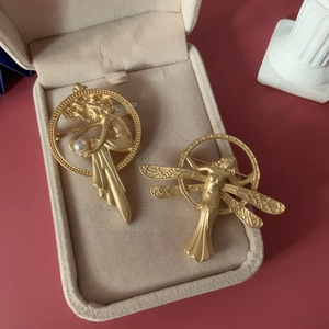 Vintage matte gold baroque angel brooches with white pearls in a jewelry box
