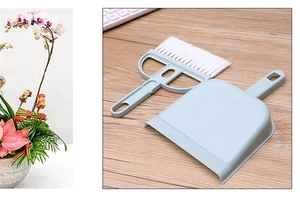 Mini desktop cleaning set featuring light blue broom nested in dustpan on wooden surface