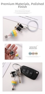 Detail of cute colorful hot air balloon and binoculars charms on metal keychain