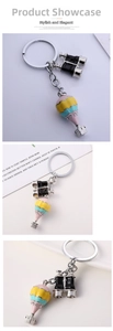 Detail of colorful enamel hot air balloon charm and binoculars keychain on ring