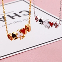 Detail of gold and silver playing card suit pendants with black and red enamel finish