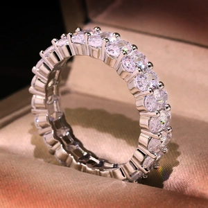 Macro shot of silver ring featuring a full circle of sparkling oval-cut cubic zirconia