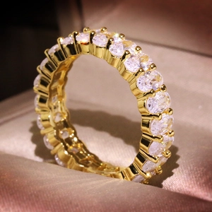 Macro shot of gold eternity ring with oval-cut cubic zirconia in a jewelry box