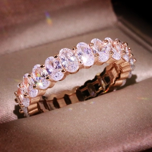 Macro shot of rose gold band set with oval-cut sparkling cubic zirconia stones in a box