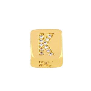 Macro detail of square gold plating charm with crystal inlaid letter K for DIY jewelry