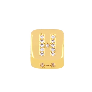 Macro detail of gold plated cubic bead with white zircon pave setting capital letter H