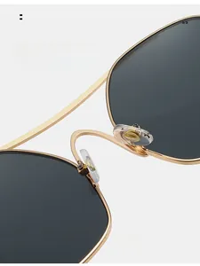 Close-up of comfortable silicone nose pads on gold metal sunglasses with anti-slip detail