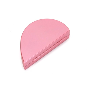 Macro shot of the pink D-shaped ring box featuring a metal hinge and matte finish