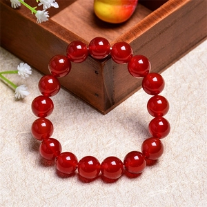 Natural 7A red agate crystal bead bracelet with high gloss polished finish on light background