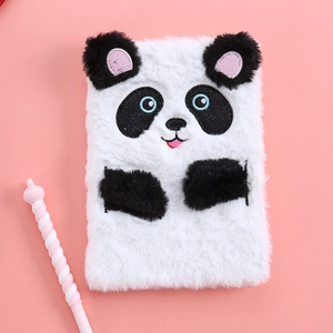 Macro detail of plush panda notebook and decorative pen on pink background