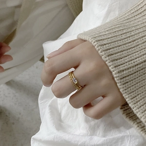 Close-up of dual gold 925 sterling silver rings featuring a rectangular zircon stone