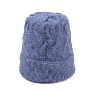 Detail of smog blue cable knit beanie featuring thick texture and folded cuff design