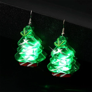 Detail of glowing green Christmas tree earrings with festive red white stripes