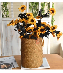 Detailed view of hand-woven straw basket with leather handle holding sunflowers