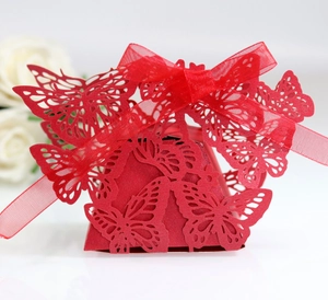 Detailed laser-cut red butterfly favor box with elegant organza ribbon for weddings