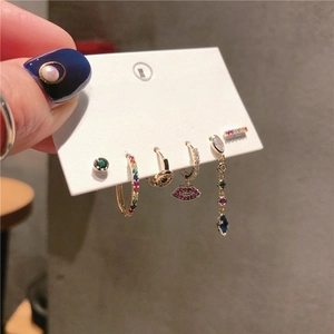 Close-up of a 6-piece earring set featuring colorful zircons and a lip-shaped charm
