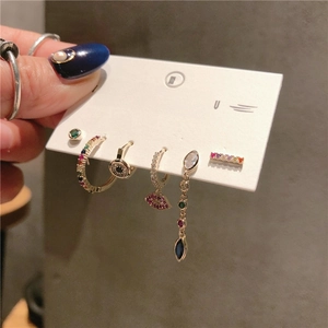 Set of 6 gold earrings with colorful zircon in lip and eye shapes on silver posts