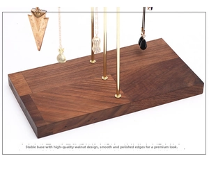 Close-up of premium walnut wood base with golden metal hooks for necklace display