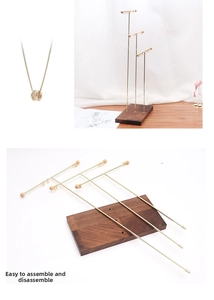 Three-tier gold metal necklace stand with walnut wood base showing easy assembly details