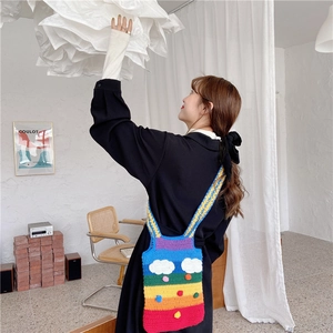 Rainbow hand-crocheted shoulder bag featuring white clouds and colorful polka dots