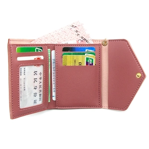 Three-fold minimalist women's wallet in dusty pink with multiple card slots and snap closure