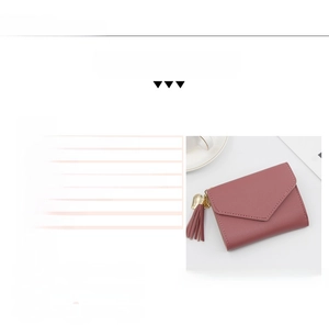 Detail view of pink PU leather wallet showing 7 card slots and a tassel charm