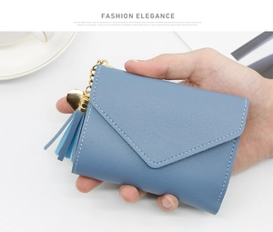 Blue mini tri-fold purse in pebble PU leather with tassel and gold heart charm detail