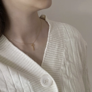 Golden vintage 925 silver cross necklace shown on a model neck with a cozy knitted sweater