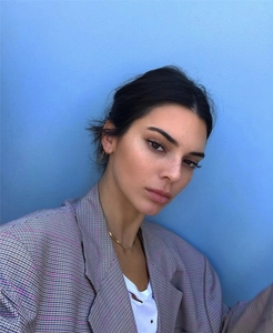Close-up of elegant 18K gold plated flat snake chain choker on model wearing a plaid blazer
