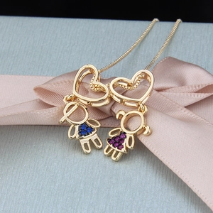 Detail of heart pendant necklace featuring boy and girl charms with colorful zircons